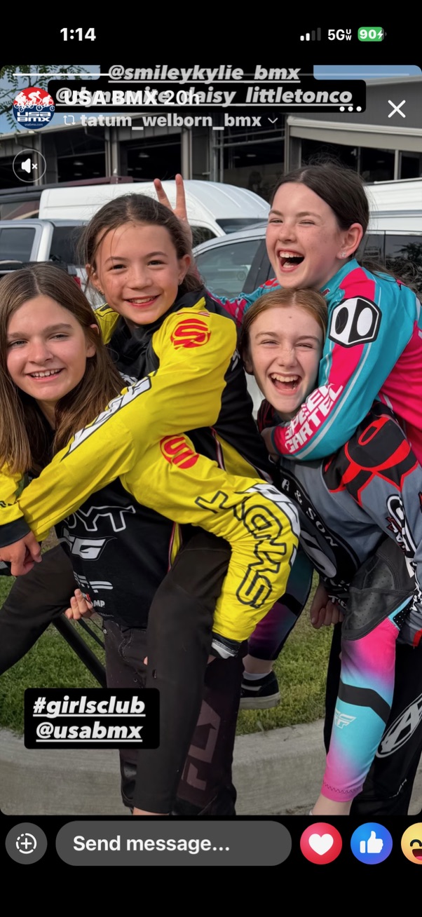Young BMX racers celebrating together at the track